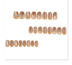 Macro detail of short square-round press-on nails with amber cat-eye magnetic shimmer