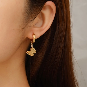 Fashionable 18K gold-plated stainless steel butterfly hoop earrings worn by a model
