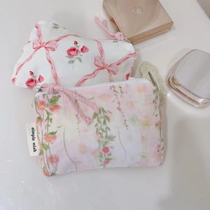 Detailed view of floral cotton mini pouches with zipper closure and simple wish labels