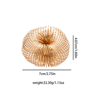 Macro detail of golden spring bracelet showing 7cm diameter and 32.3g weight specs