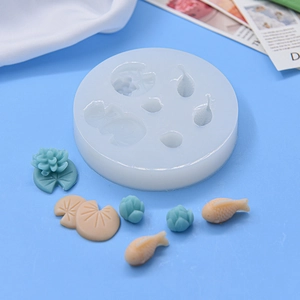 Lotus and fish silicone mold with clay crafts on a blue background in 45-degree view