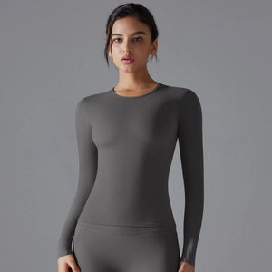 Close-up of women's dark gray long-sleeve yoga top featuring high-stretch slim fit fabric