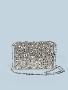 Macro shot of silver woven shoulder bag featuring metallic disc texture and chain strap