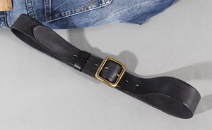 Detailed close-up of premium black leather belt with a vintage bronze pin buckle and stitching
