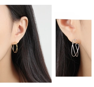 Detailed view of sterling silver geometric earrings featuring irregular intertwined wavy lines