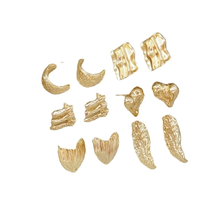 Collection of gold-plated textured earrings in heart, moon, and square geometric shapes
