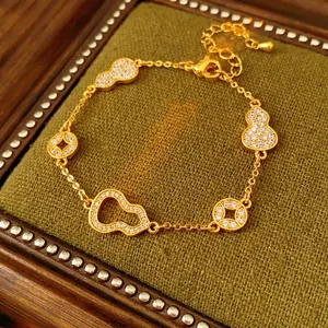 24k gold-plated hulu and coin bracelet with sparkling white zircons on green velvet