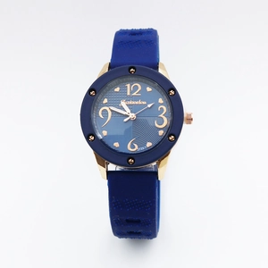 Detailed view of blue silicone strap and gold quartz dial with heart pattern design