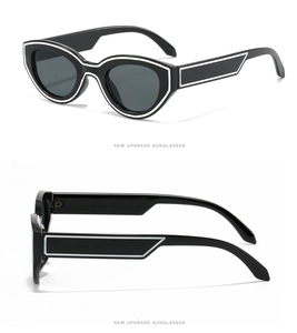 Detail view of bold black oval sunglasses with white geometric lacquer outline accents
