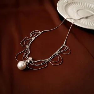 Luxurious multi-layer rhinestone necklace with oversized pearl on elegant red silk