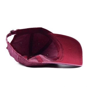 Detail view of burgundy washed cotton baseball cap with adjustable metal buckle strap