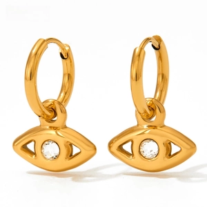 Detail of gold-plated evil eye earrings featuring a micro-set zircon pendant and huggie hoop