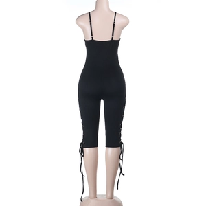 Detail of black slim fit bodysuit with lace-up side eyelets and open back design