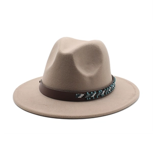 Detail of wide brim wool fedora hat featuring a bohemian leather band with woven beadwork