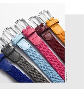Close-up of seven elastic woven belts in various colors with metallic silver pin buckles