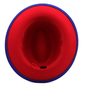 Top view detail of bicolor fedora hat showing red interior lining and blue brim texture