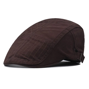 Detail view of the brown newsboy cap featuring diamond stitching and adjustable metal side buckle