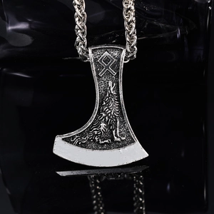Viking battle axe pendant with silver wolf totem and runes on dark mirror background