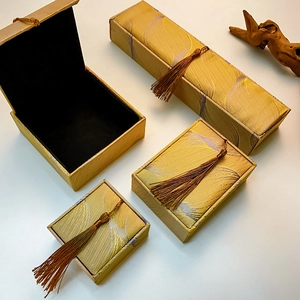 Detailed set of four vintage brocade jewelry boxes with purple waves and brown tassels