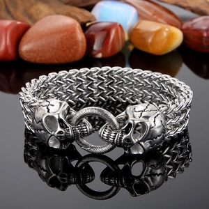 Detail of silver double skull clasp on punk style metal braided bracelet for men