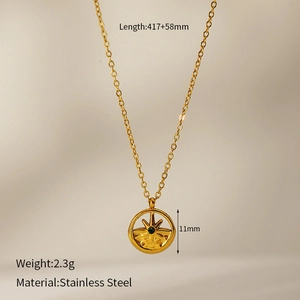 Detail of gold stainless steel necklace with 11mm starburst pendant and green stone