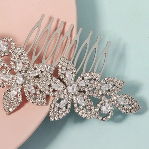 Macro detail showing silver hair comb with clear crystal flowers and sparkling rhinestones