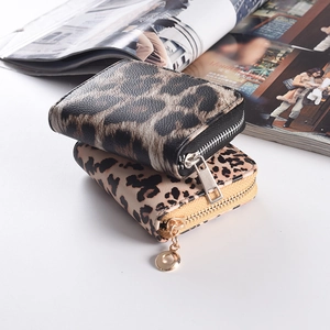 Detail showing two leopard print wallets with zipper closure and varied leather textures