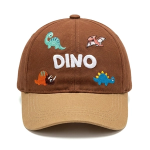 Detail of cotton baseball cap featuring embroidered cartoon dinosaurs and DINO text