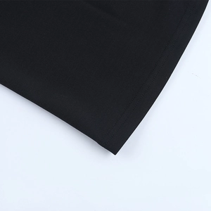 Detail shot of the fishtail dress hem featuring black knitted cotton and double-needle stitching