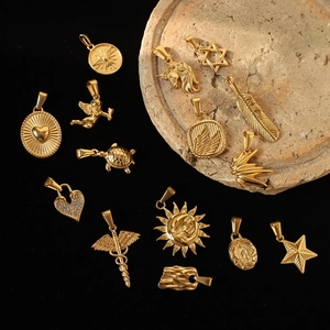 Detailed view of various vintage gold-plated pendants with sun and unicorn motifs