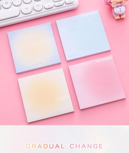 Flat lay of gradient sticky notes with aesthetic pink desk accessories and keyboard