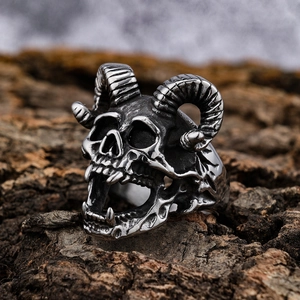 Gothic ram horn skull ring for men in polished silver stainless steel on rustic wood