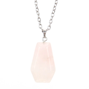 Macro detail of a hexagonal rose quartz coffin pendant with a silver alloy chain link