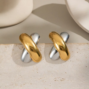 Close-up of X-shaped two-tone crossover earrings in 18K gold and silver titanium steel
