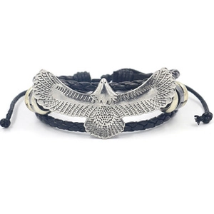 Detail of multi-layer braided leather bracelet with silver eagle and metallic beads