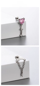 Detail of silver titanium steel earrings featuring pink heart stone and chain tassels