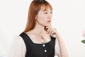 Polished rose gold square pendant necklace displayed on a model in a studio setting