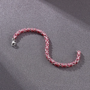 Close-up of a 4mm red and silver stainless steel king chain bracelet with lobster clasp