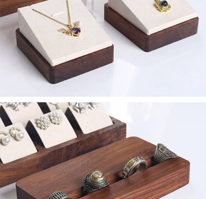Detail of walnut wood jewelry stand with microfiber lining for rings and necklaces