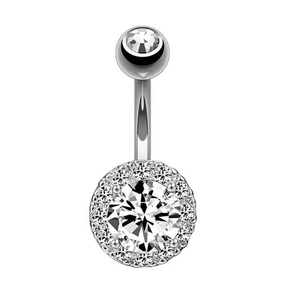 Macro detail of silver navel piercing featuring sparkling cubic zirconia heart and round stones