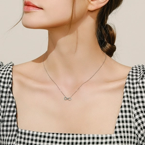 S925 sterling silver infinity necklace with turquoise stones worn by a model