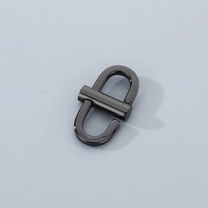 Detail of a black metal U-shape chain buckle and adjuster for handbag straps