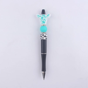 Close-up of creative cow bead pen featuring turquoise beads and silicone cow topper