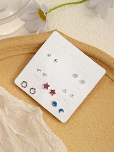 Detailed set of seven pairs of assorted alloy stud earrings on a weekly fashion card