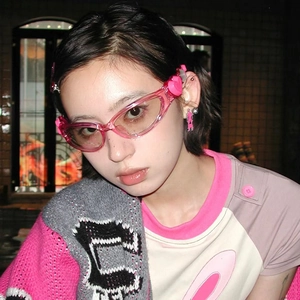 Close-up of pink transparent Y2K heart sunglasses on model with soft jelly texture