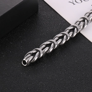 Macro shot of silver woven knot chain with antique finish on premium dark background