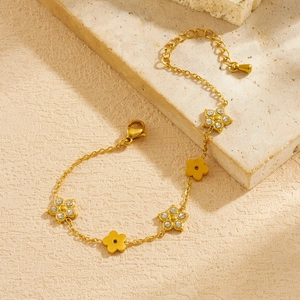 Detailed macro shot of gold plated floral chain bracelet with sparkling crystal accents