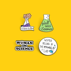 Set of four science themed enamel pins with laboratory flasks and creative slogans