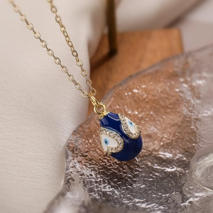 Macro shot of egg-shaped evil eye pendant with blue enamel and sparkling cubic zirconia