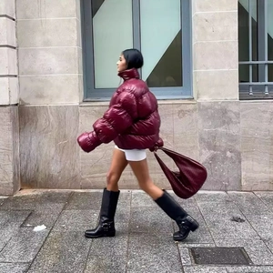 Oversized burgundy glossy puffer jacket with high neck for women in urban street style